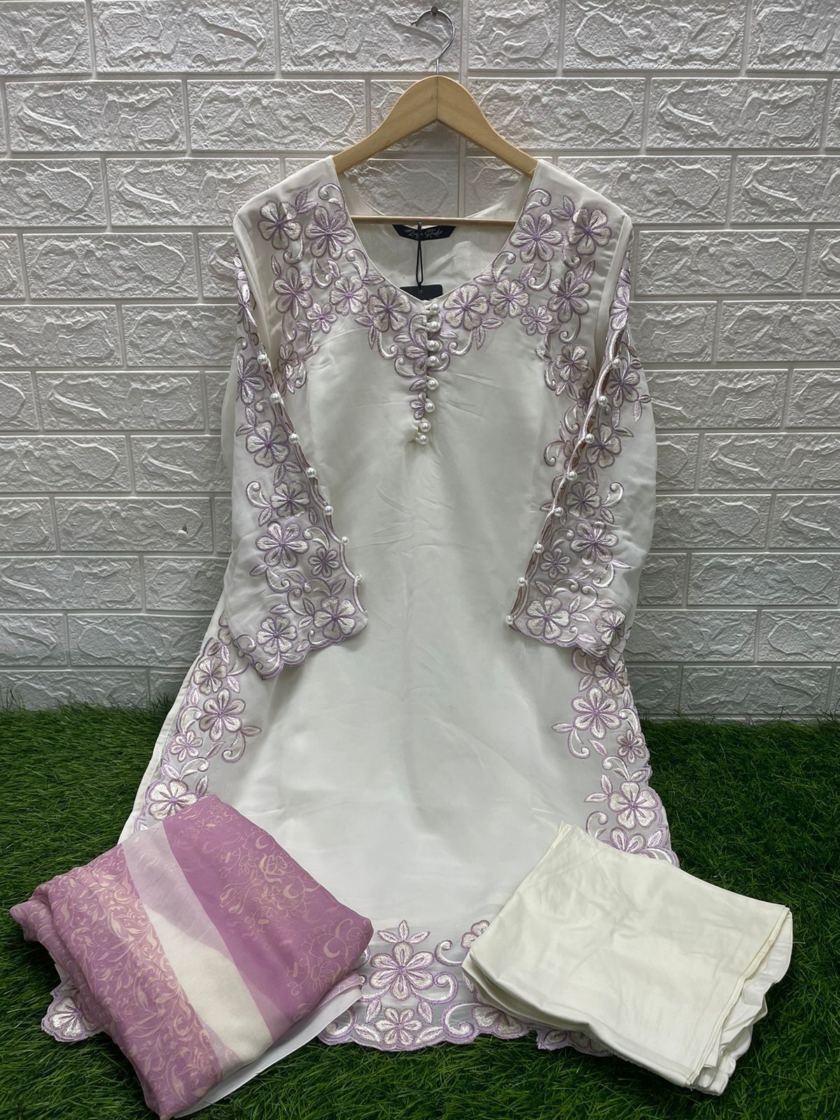 Georgotte straight shirt with heavy embroidered cutwork details beautifuly composed all over the shirt and sleeves with scalloped edging and sleek straight cut button down neckline